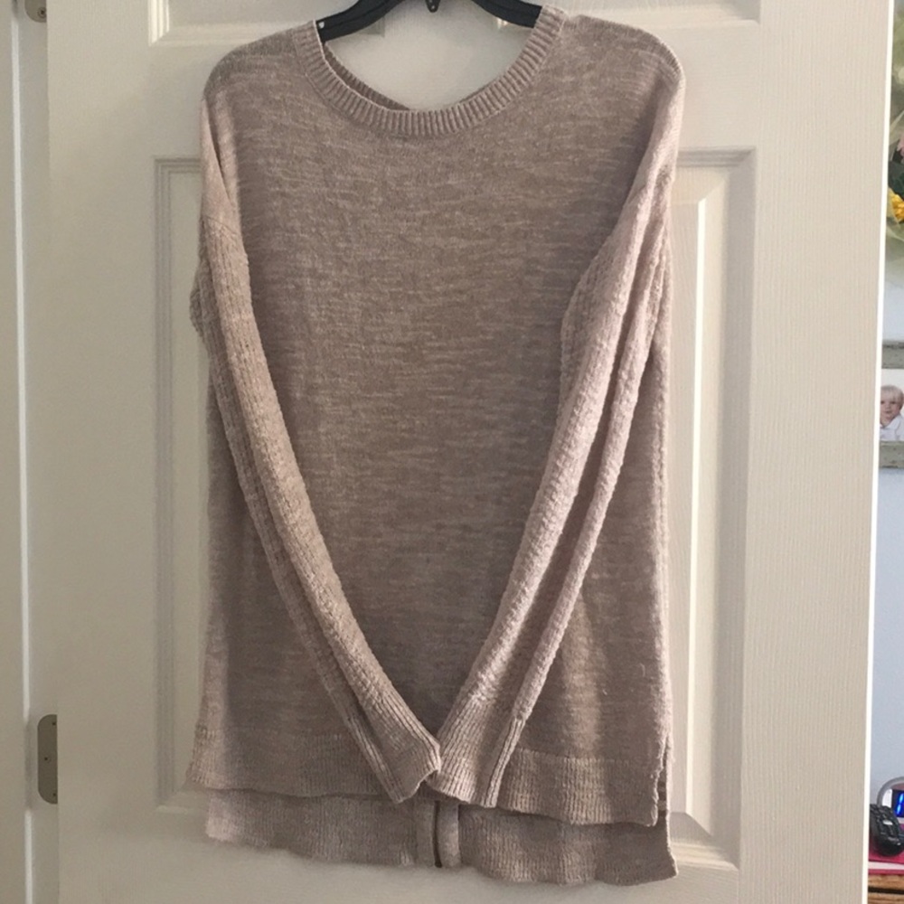 Tunic length sweater with zipper detail.